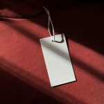 Blank tag hanging on a red garment