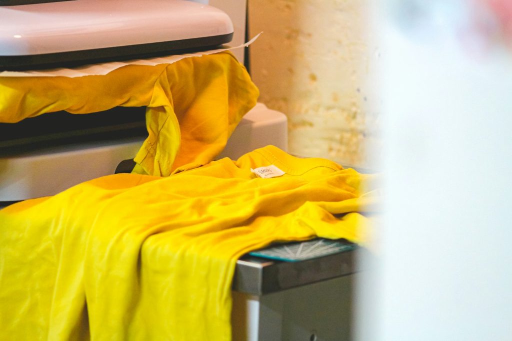 Yellow t-shirt laid on a heat press