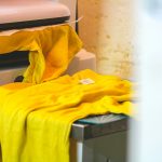 Yellow t-shirt laid on a heat press