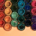 Open pots of coloured pigment seen from above
