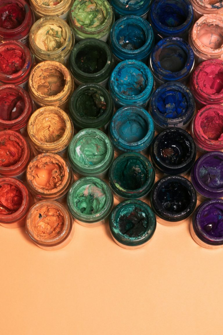 Open pots of coloured pigment seen from above