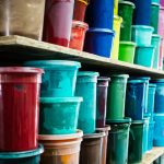 Shelves of colourful printing paste and ink buckets