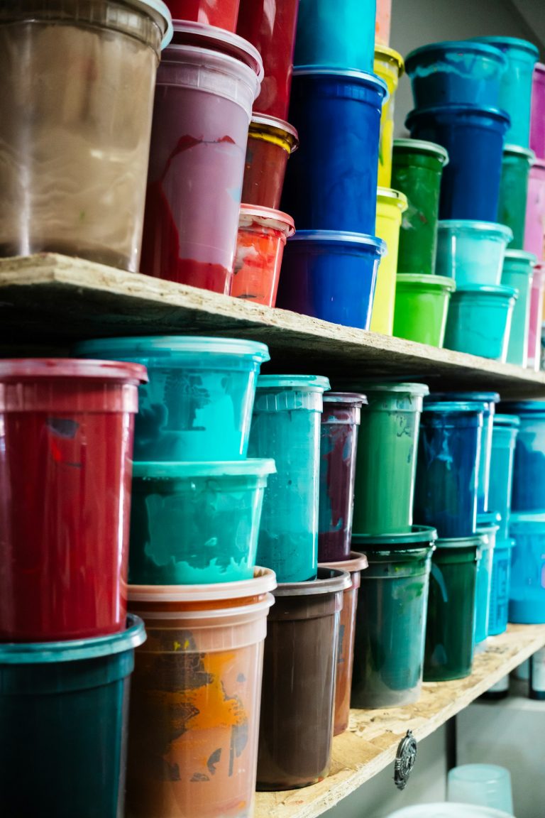 Shelves of colourful printing paste and ink buckets