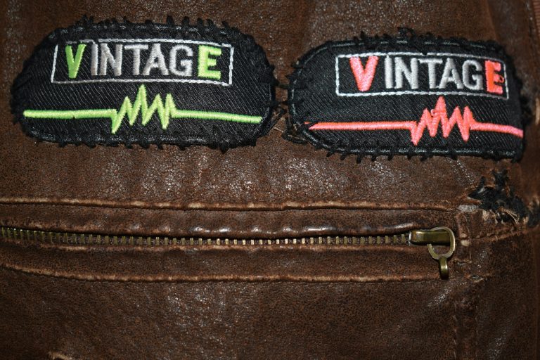 Two embroidered patches on a brown leather jacket