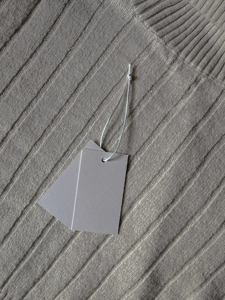 Grey tag on a ribbed knit garment