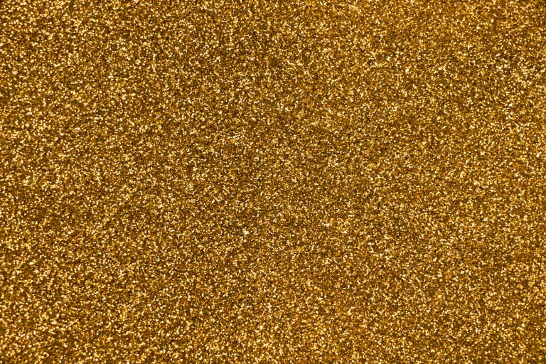 Close-up of gold glitter catching the light