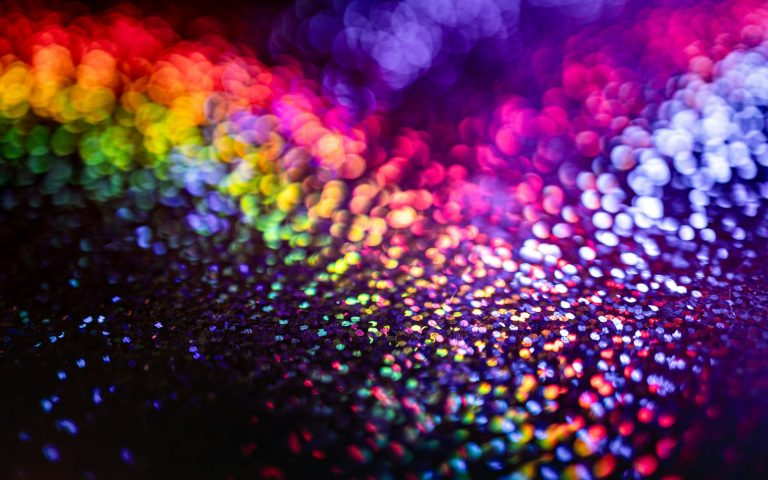 Multicoloured glitter sparkling from red to violet