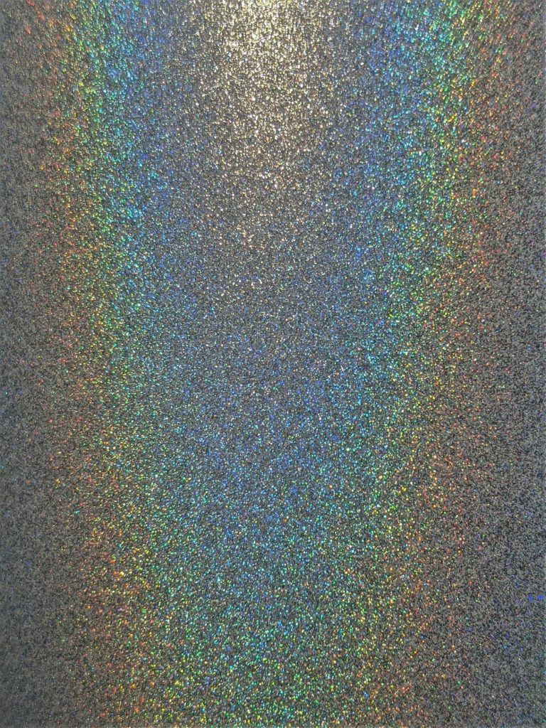 Iridescent glitter reflecting rainbow light