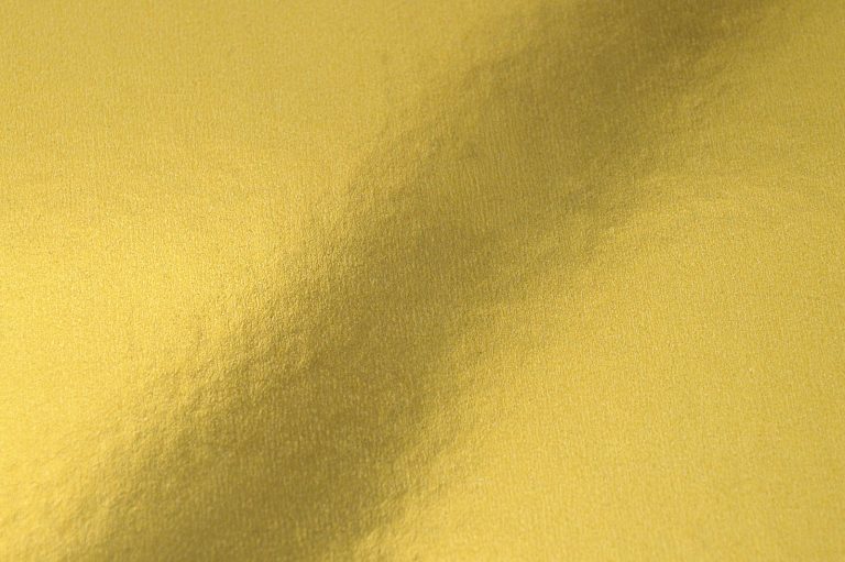 Smooth sheet of gold foil with a soft reflection