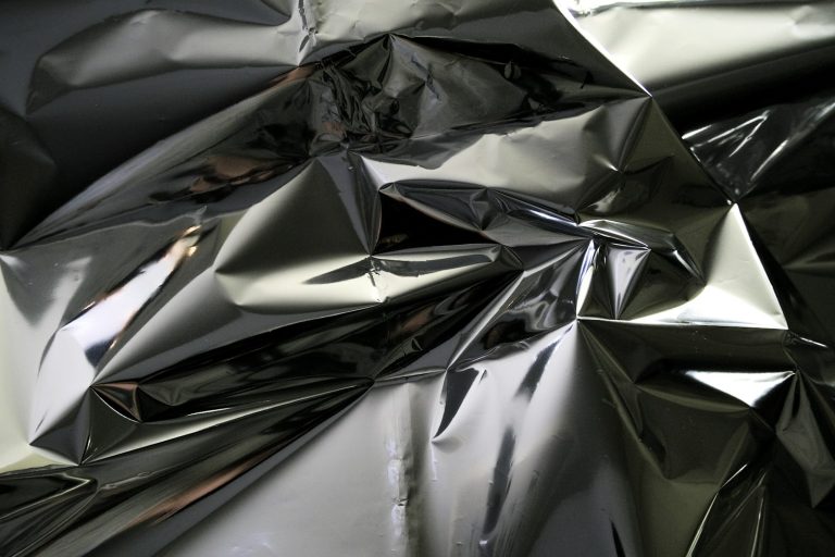 Folded silver foil with dark reflections
