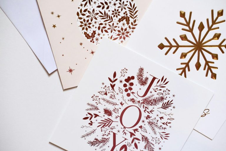 Red and copper foil designs printed on white cards