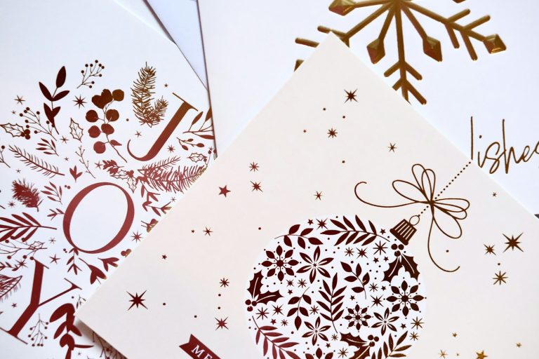 Cards with red foil lettering and copper foil snowflakes