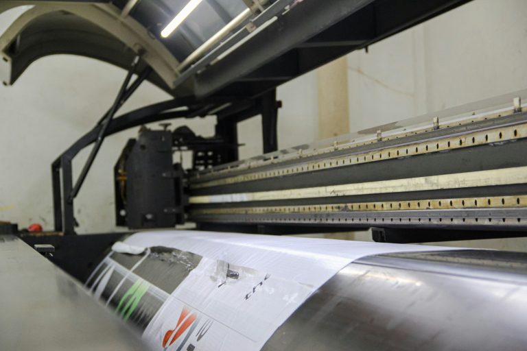 Printed film coming out of a wide-format printer