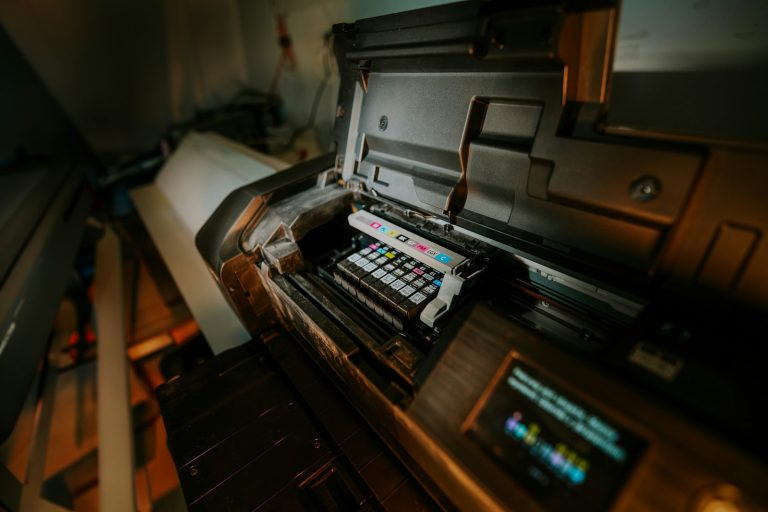 Open large-format printer showing its ink system
