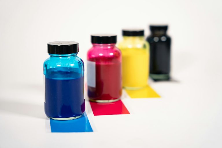 Bottles of cyan, magenta, yellow and black ink