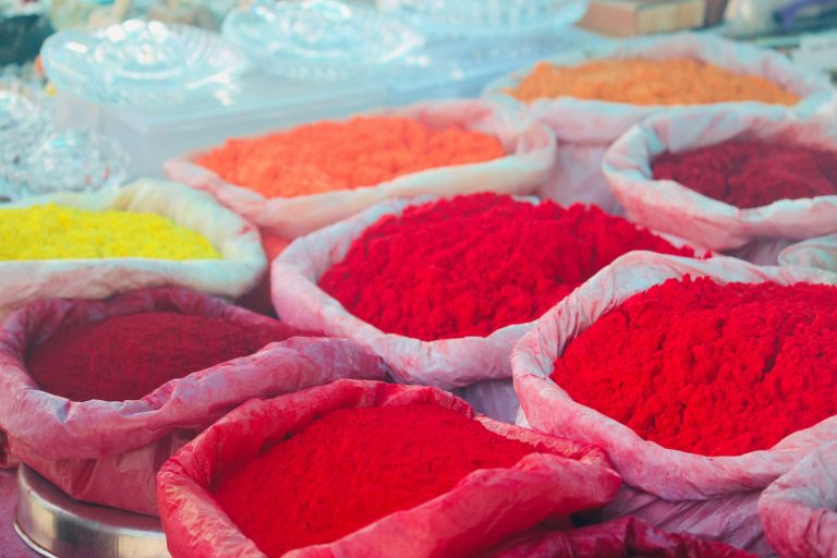Sacks of red, orange and yellow pigment powder