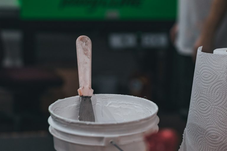 Bucket of white printing paste with a spatula