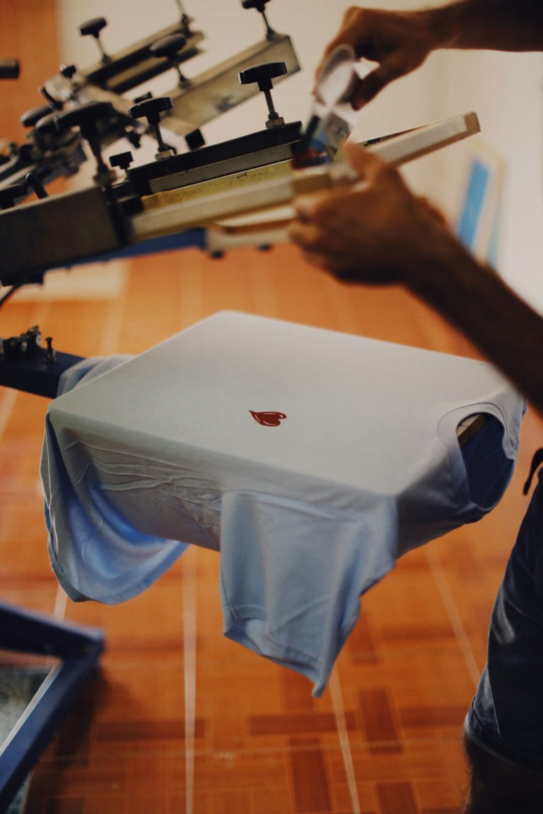 T-shirt loaded on a manual screen printing press